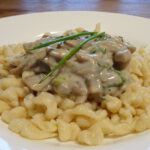 selfmade German spaetzle with a mushroom cream sauce