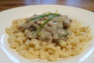 selfmade German spaetzle with a mushroom cream sauce